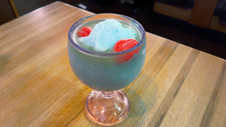 The Shark Bowl from Applebee's garnished with candy lips in a mucho goblet