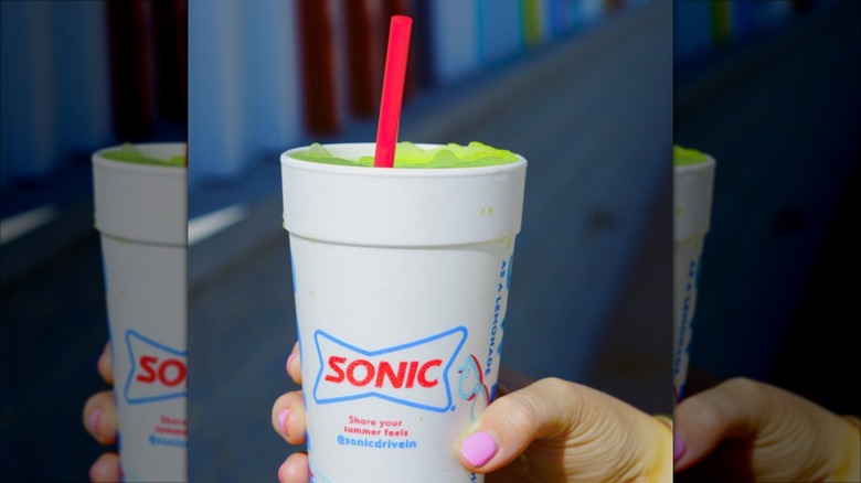 Hand holding Sonic Pickle Juice Slush