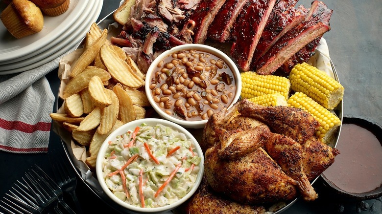 A barbecue platter with meats and sides at Famous Dave's