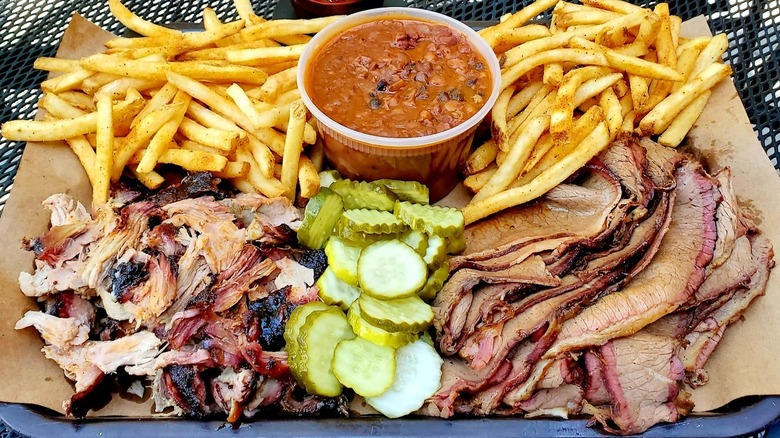 A barbecue platter with fries, baked beans, and pickles at Joe's Kansas City Bar-B-Que