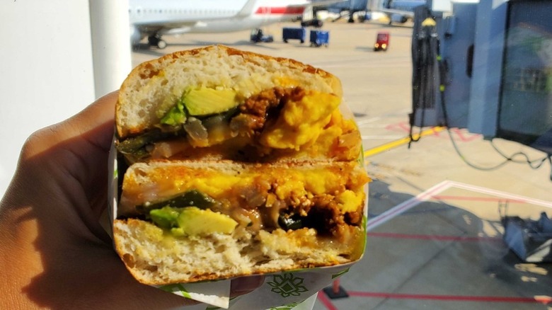 A breakfast torta with egg and avocado cut in half