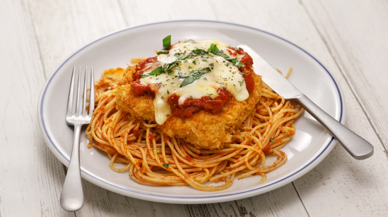 A plate of chicken Parmesan on pasta