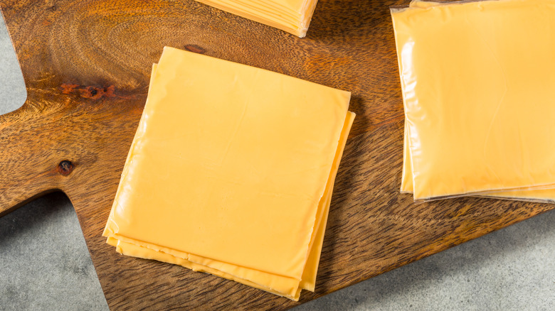American cheese slices on cutting board