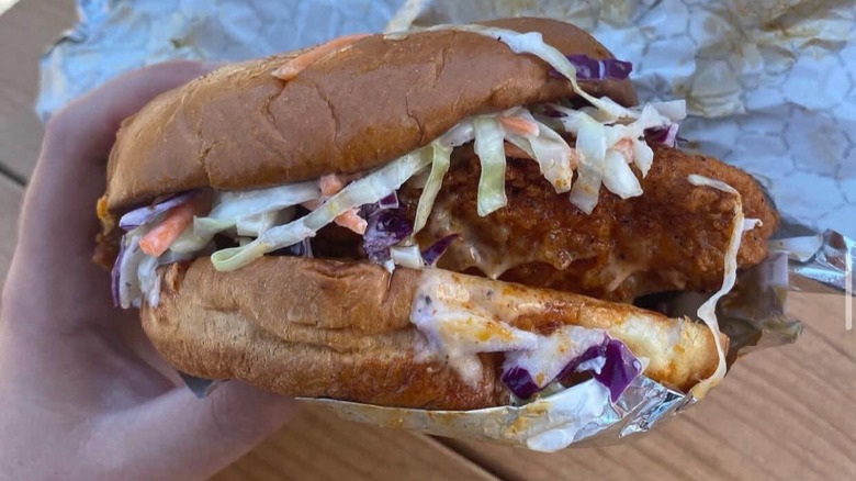 Someone holding the Signature Chicken Sandwich from Mico's