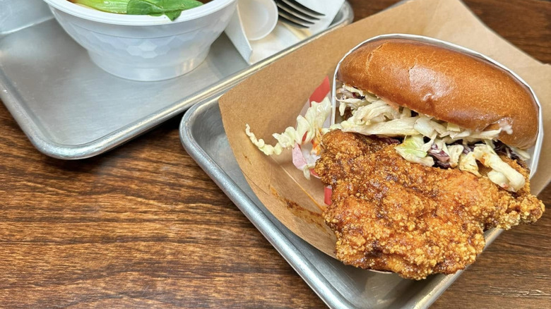 A Szechuan Chicken Sammy on a tray at AtCha