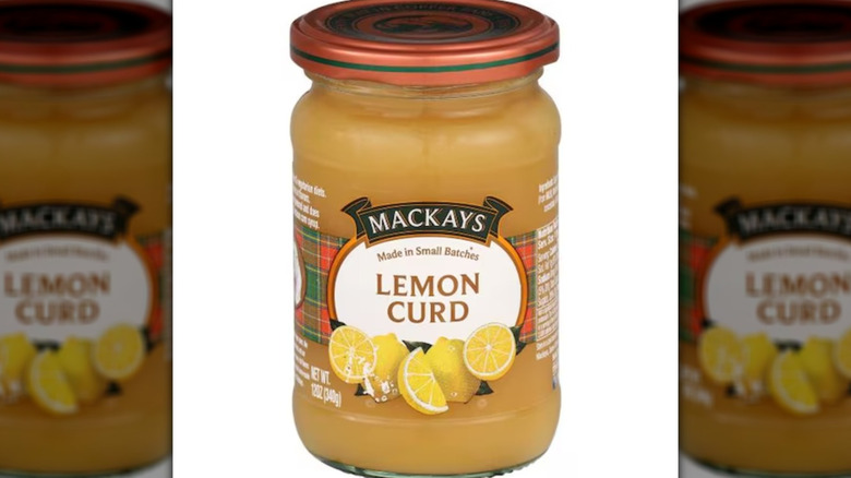Mackays Lemon Curd in a glass jar with an orange lid.