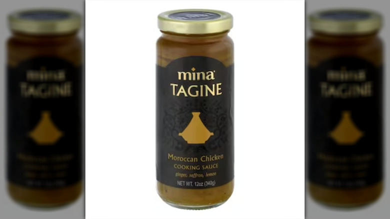 Mina Cooking Sauce, Morrocan Chicken Tagine sauce in a tall glass jar with a gold lid.