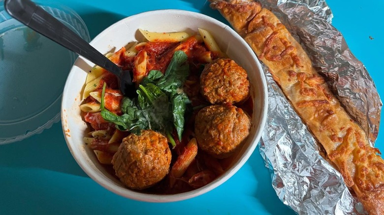 A bowl of pasta and a Parmesan piada stick from Piada Italian Street Food