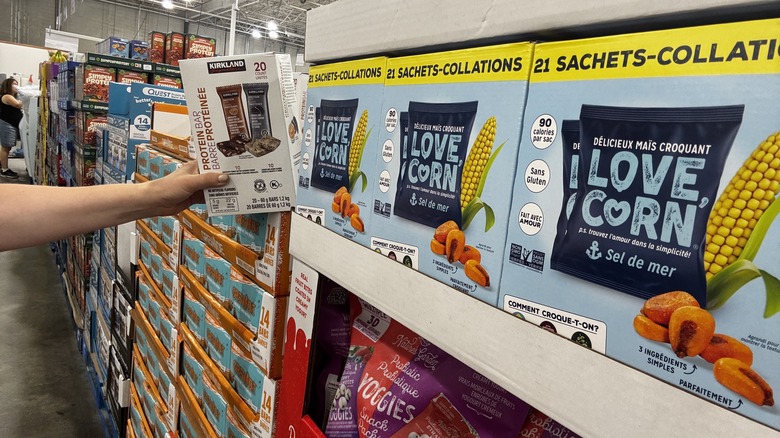 Grabbing protein bars off the shelf at Costco