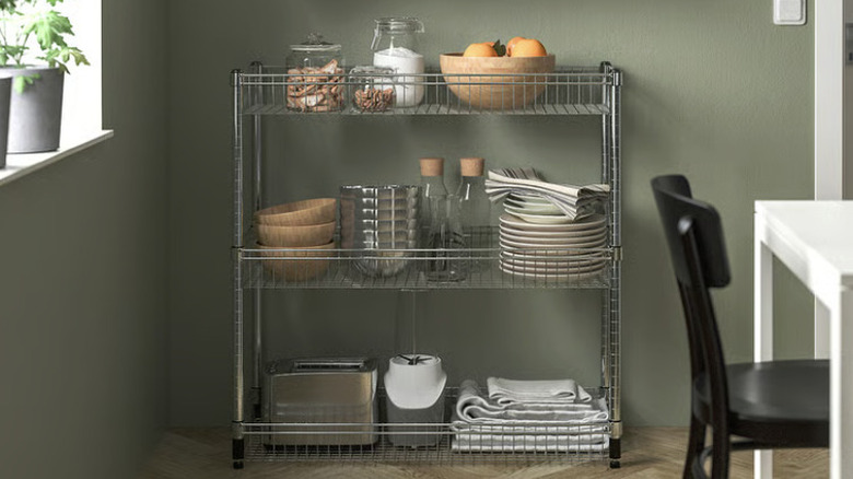 OMAR shelving unit storing various items in a dining space