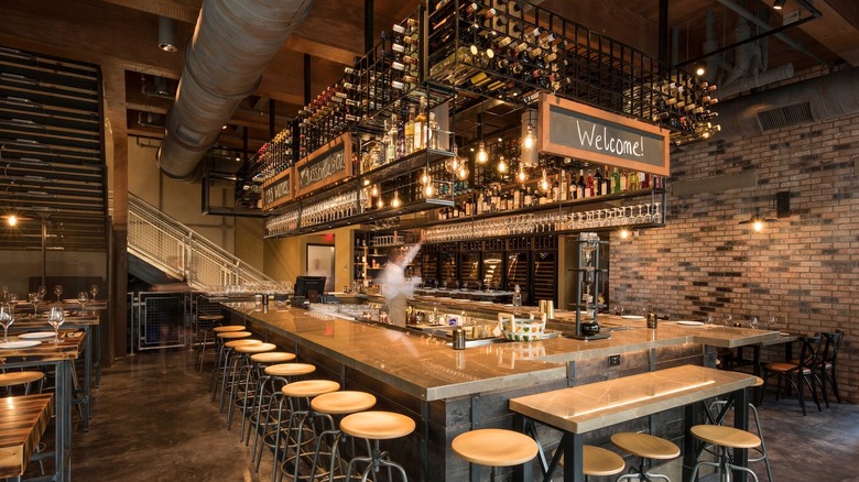 Rustic bar with wooden stools and exposed brick walls