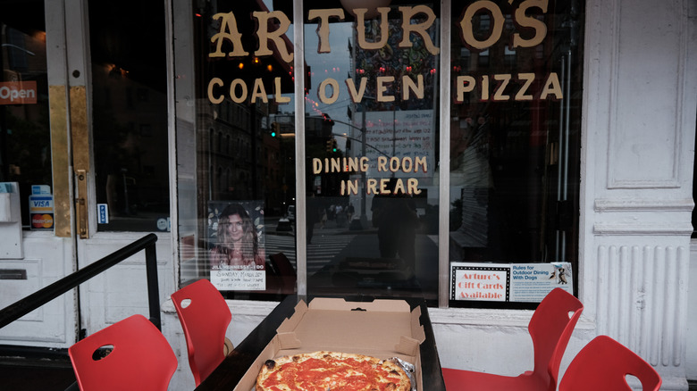 Entrance of Arturo's Coal Oven Pizza with pizza on table outside