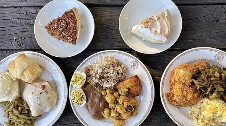 Plates of soul food arranged on a wooden table