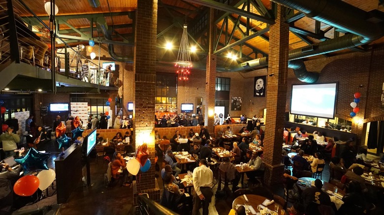 Large brick dining room filled with people