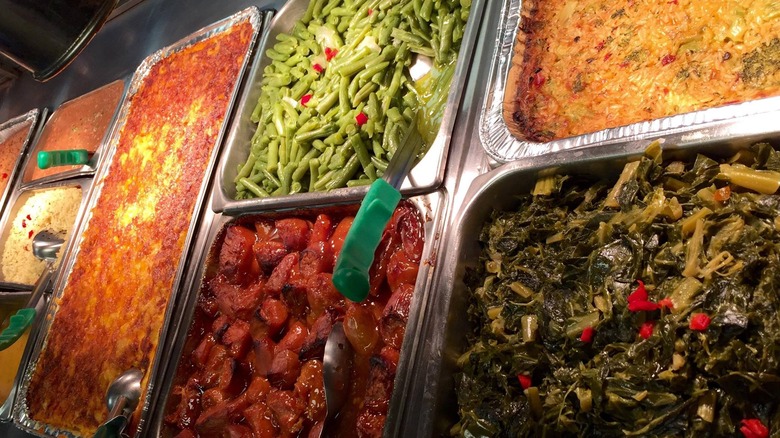 Aluminum pans of soul food on a buffet line