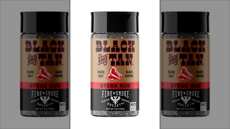 a shaker of Fire & Smoke Society Black & Tan Steak Rub on white background