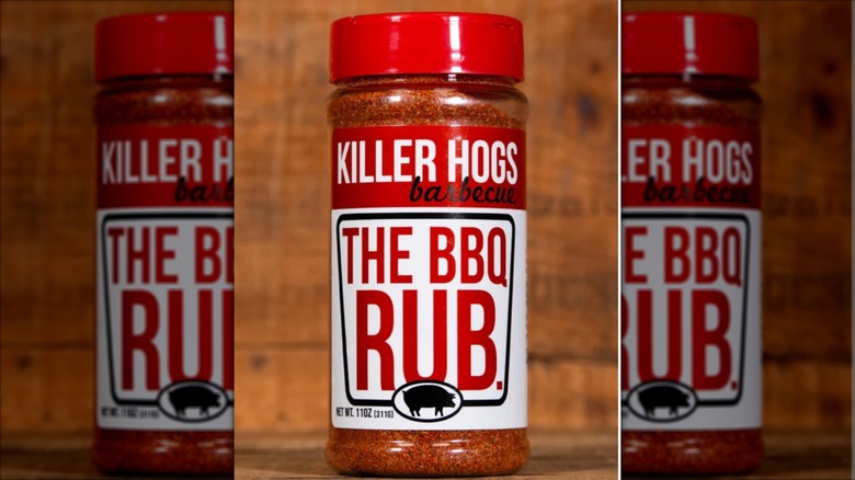 a shaker of Killer Hogs Barbecue The BBQ Rub on a wooden background
