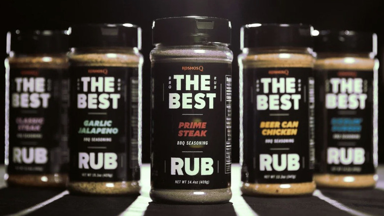 five shakers of Kosmos Q dry rub on a black background