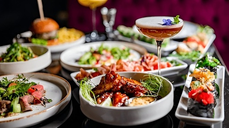 Spread of assorted appetizers and an alcoholic beverage on display at a cocktail party