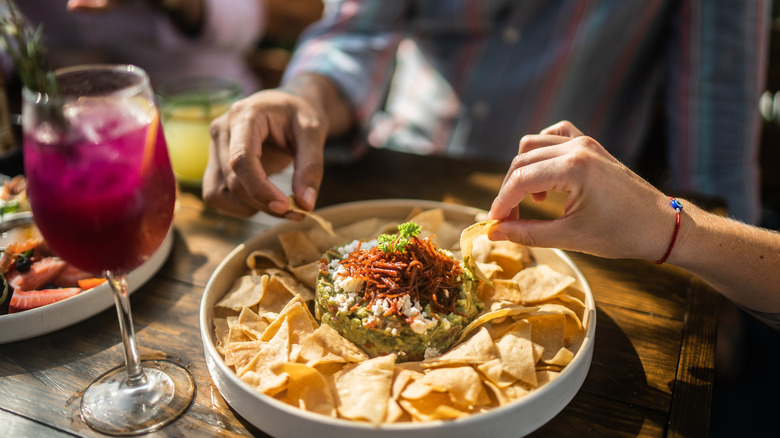 People eating guacamole at a restaurant