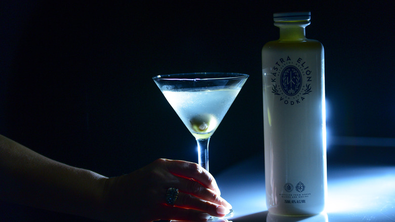 A bottle of Kastra Elion next to a martini glass with dramatic lighting