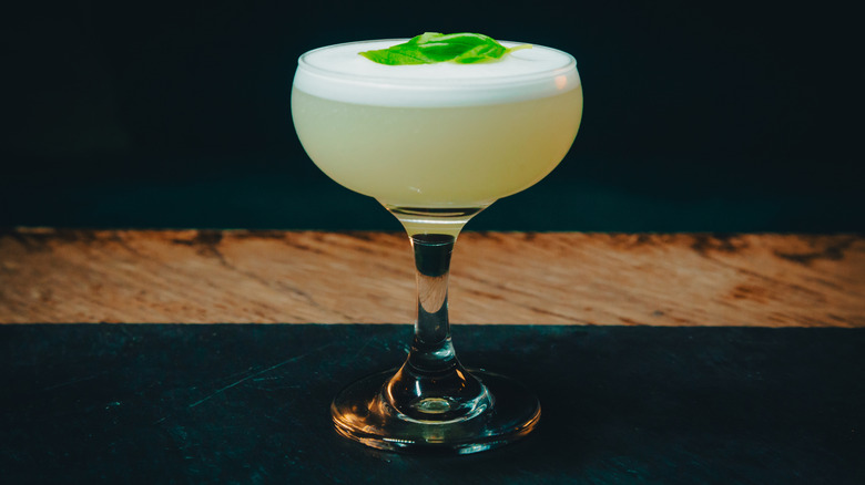 Mocktail with a leaf garnish on a table