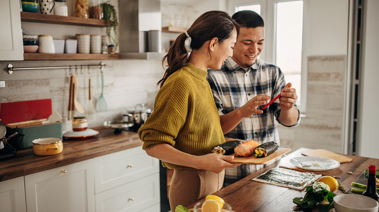 Couple in a kitchen preparing food together