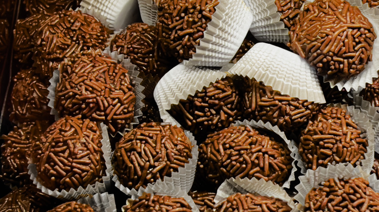 Brigadeiros rolled in chocolate sprinkles and wrapped in paper