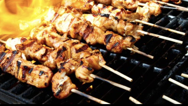 Espetinhos grilling on open flames