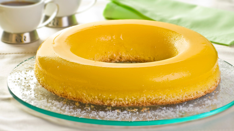 A large, ring-shaped quindim on a glass serving plate