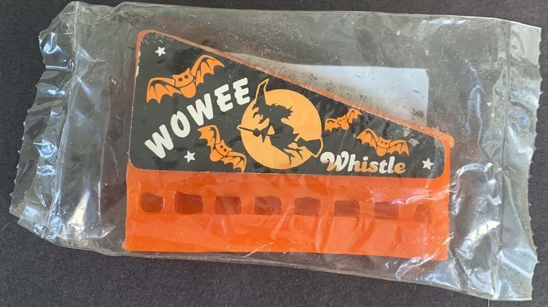 A Wowee Whistle wax harmonica with Halloween-themed sticker in a plastic wrapper