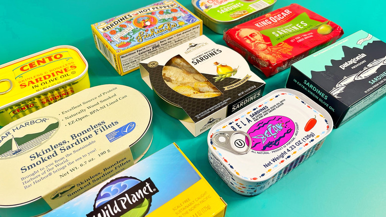 9 cans of sardines still in their packaging on a teal background