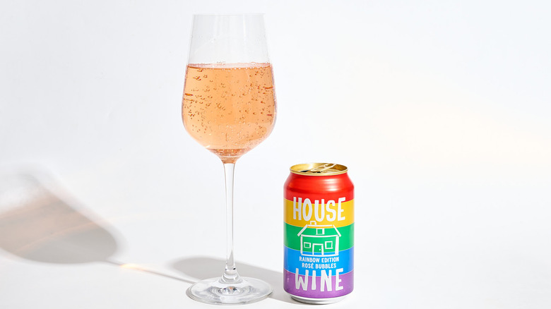 Can of House Wine Rosé Bubbles next to a filled wine glass