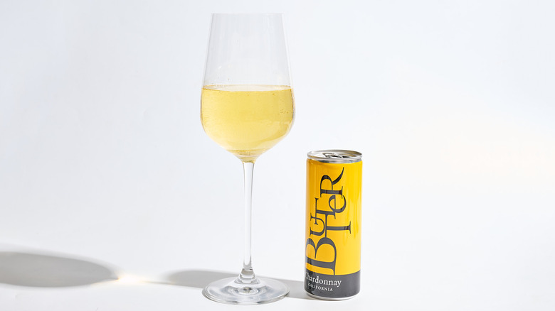Can of Butter Chardonnay next to a filled wine glass