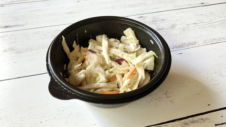 Bonefish Grill coleslaw in a black plastic take-out container
