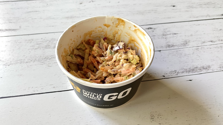 Buffalo Wild Wings coleslaw in a black take-out container