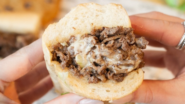A person holding a Classic Cheesesteak at Capriotti's