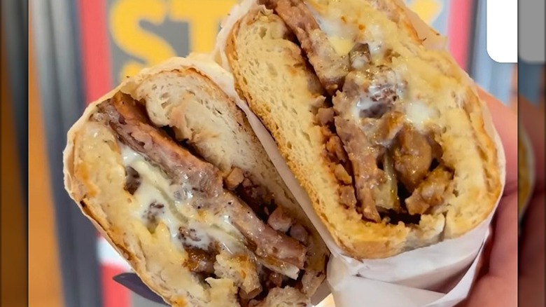 A person holding a Prime Rib Steak at Potbelly Sandwich Works