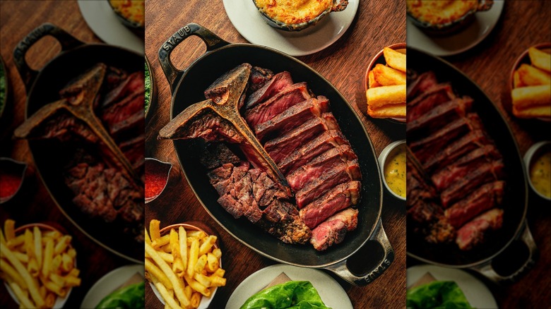 Sliced porterhouse served on a cast iron skillet