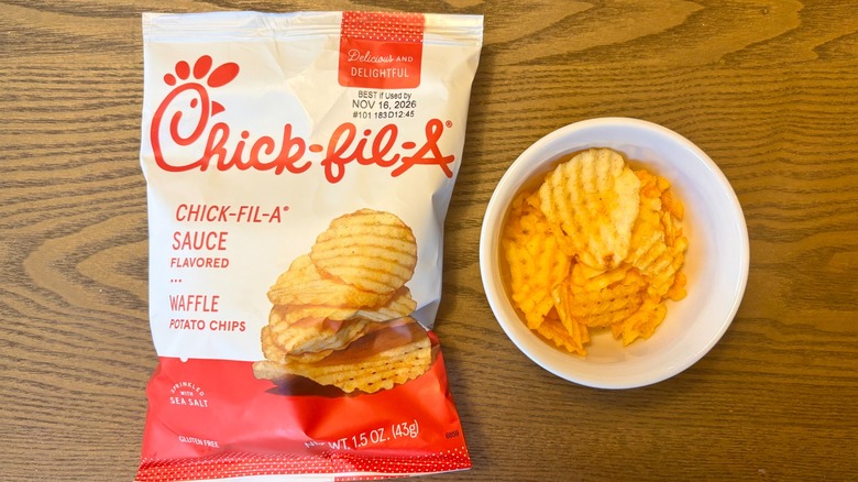 A bag of Chick-fil-A Sauce Flavored Waffle Potato Chips next to a small bowl of the chips
