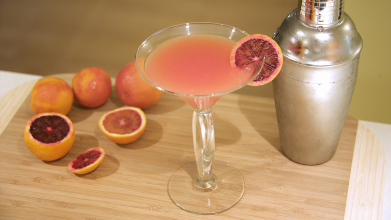 Blood Orange Cosmopolitan with sliced oranges and cocktail shaker