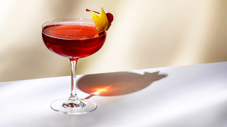 London Cosmopolitan with lemon twist on a white background