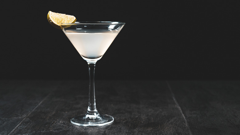 White Cosmopolitan with lime wedge on black background