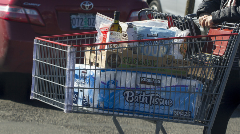 cart loaded with Costco bath tissues and other groceries