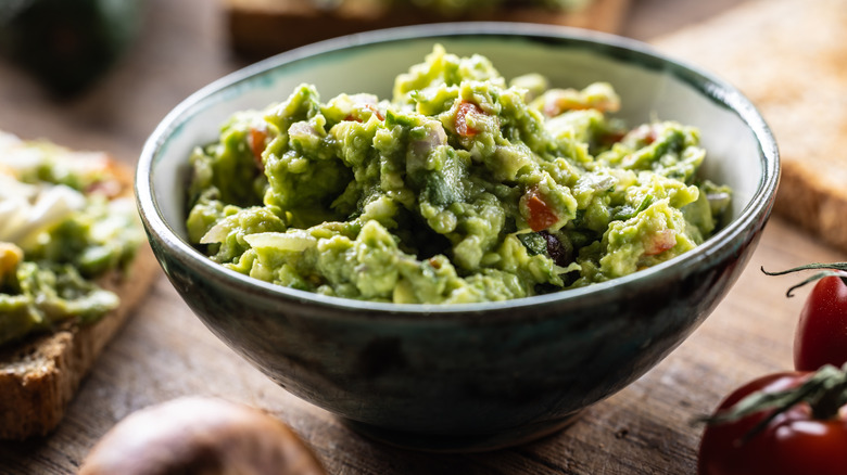 Bowl of fresh guacamole on a table