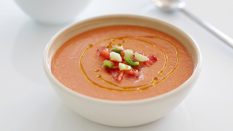 Gazpacho with a vegetable garnish and oil drizzle