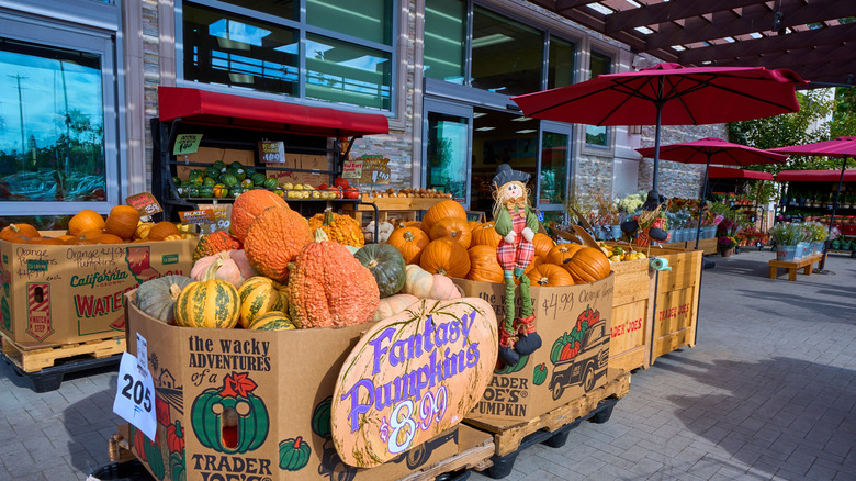 The exterior of a Trader Joe's during fall, with lots of pumpkins on display