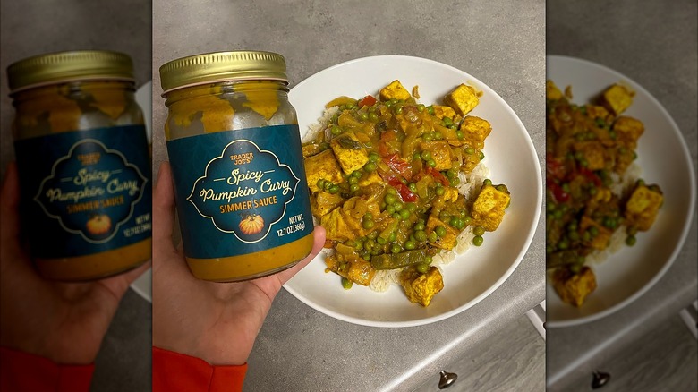 A hand holding a jar of the Pumpkin Curry Simmer Sauce next to a plate of tofu curry