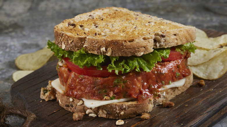 Turkey meatloaf sandwich with lettuce, tomato, cheese, and toasted multigrain bread