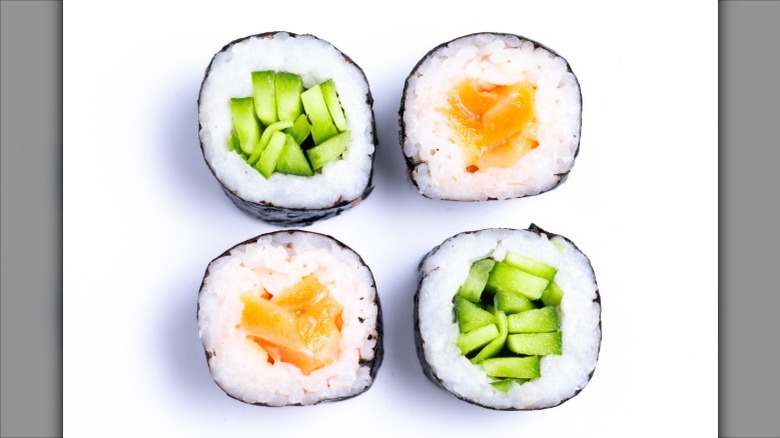 Four rolls of maki sushi, two cucumber (kappa maki) and two salmon